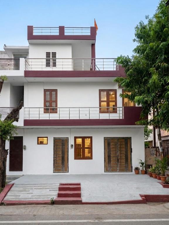 a large white house with a lot of windows at Private Duplex Stay with Open Terrace in Meerut