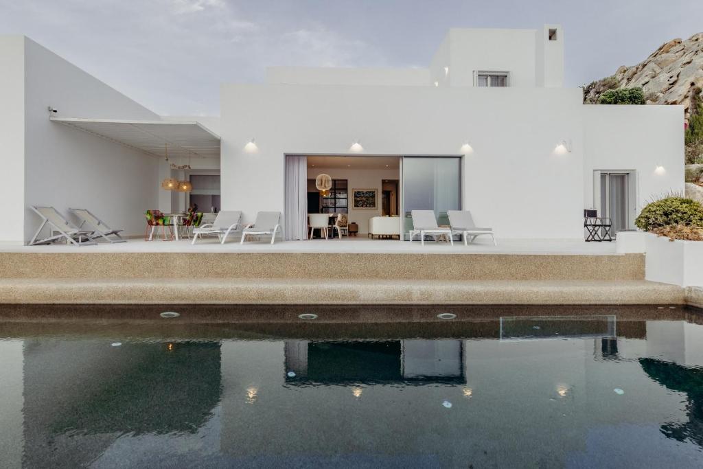a house with a pool in front of it at Villa Paschalia,Sea View, Pool, Gym, Sleeps 10 in Mikonos