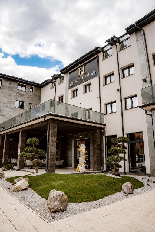 a building with a lawn in front of it at Atrium Hotel in Vulcan