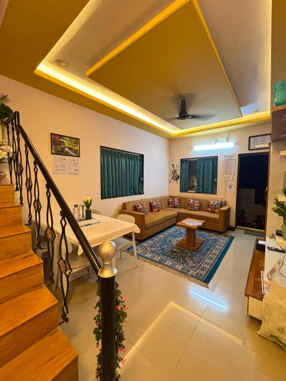a living room with a couch and a table at Tranquil Trails-Suprabha Villa-Nashik in Nashik