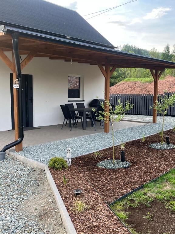 a pavilion with a table and chairs in a yard at Nest Haus in Ludwikowice Kłodzkie