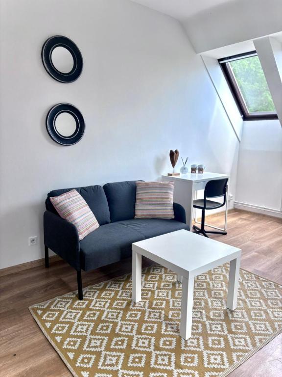 a living room with a blue couch and a table at OLD TOWN Olsztyn in Olsztyn