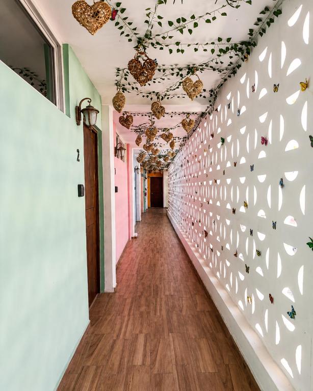 a hallway with a wall decorated with butterflies at Puul Suites in Mérida