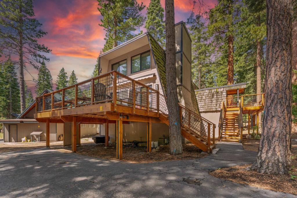 a house with a large deck in the woods at Agate Bay Chalet in Carnelian Bay