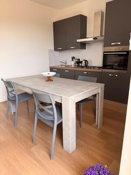 a kitchen with a table and chairs in a room at Oasi di Comago in Sant'Olcese