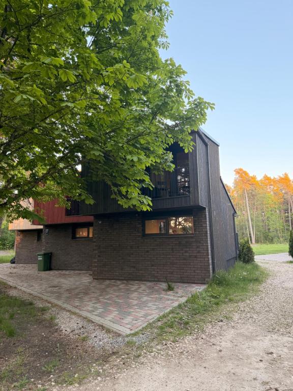 a brick house with a tree in front of it at Shells & Pines in Jūrmala