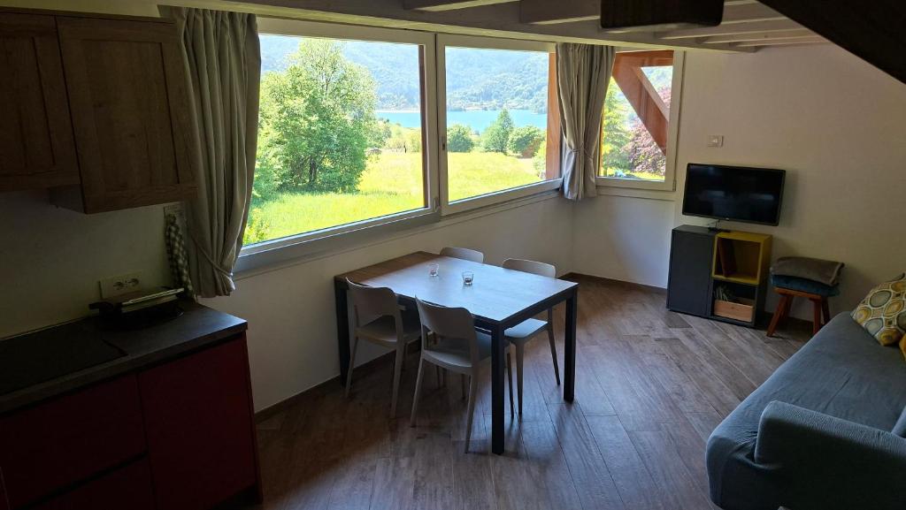 a living room with a table and a couch at Ledro Nest in Ledro