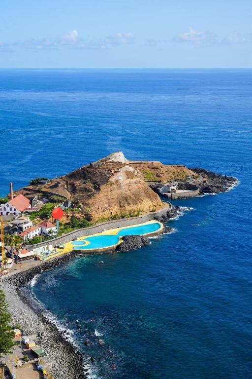 an aerial view of an island in the ocean at Maresia Gardens in Porto da Cruz