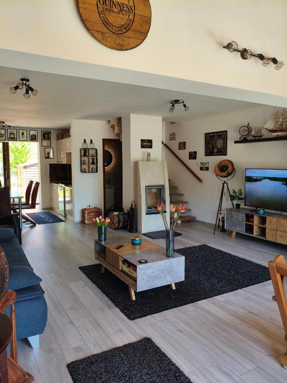 a living room with a blue couch and a table at Miliő Apartman Sarud in Sarud