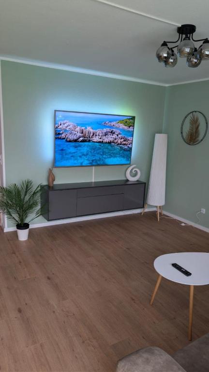 a living room with a flat screen tv on a wall at 2 Zimmer Ferienwohnung nahe Schweiz in Bad Säckingen