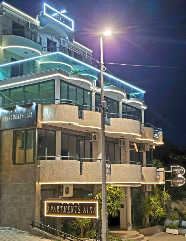 a street sign in front of a building at night at Apartmens Aida Luks in Ulcinj
