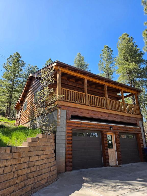 a house with a deck and a garage at Cozy Forest Cabin with Hot Tub in Central Flagstaff in Flagstaff