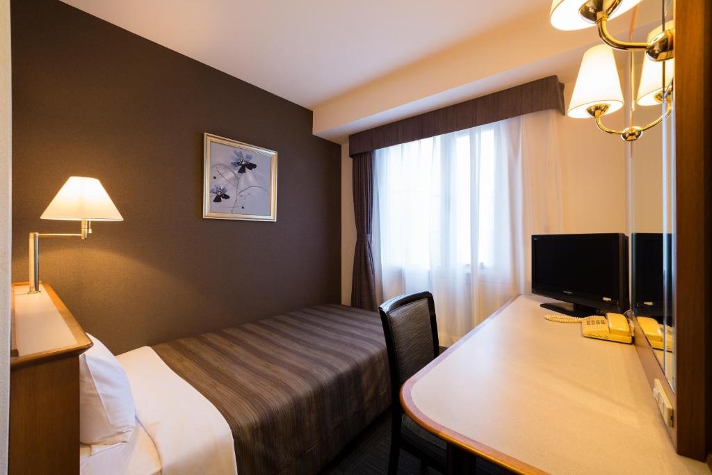 Postel nebo postele na pokoji v ubytování Ark Hotel Osaka Shinsaibashi -ROUTE INN HOTELS-