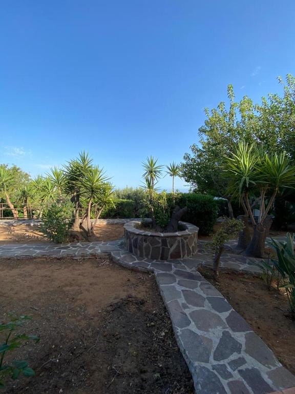 a garden with a stone walkway and a fire pit at Casa Sciavè - Paradise in Sciacca in Sciacca