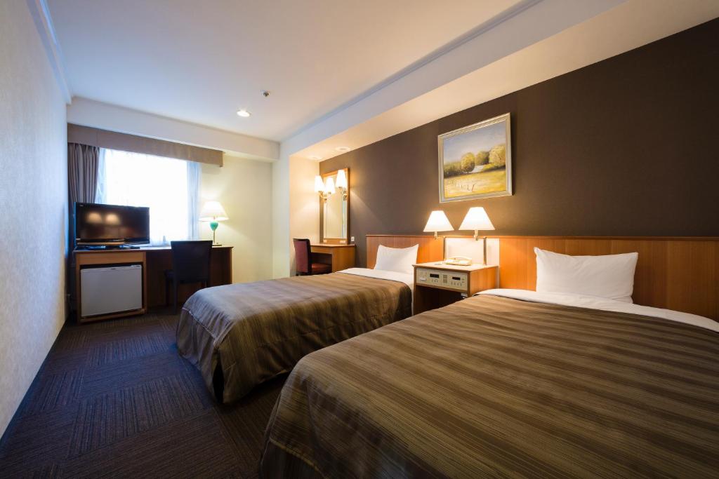 Postel nebo postele na pokoji v ubytování Ark Hotel Osaka Shinsaibashi -ROUTE INN HOTELS-