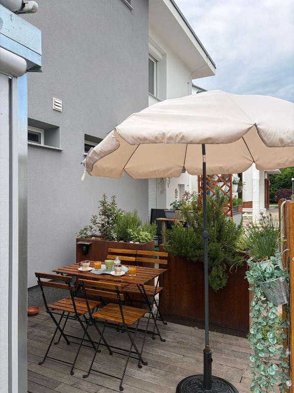 a table and chairs under an umbrella on a patio at Studio apartma Rimljanka in Ptuj