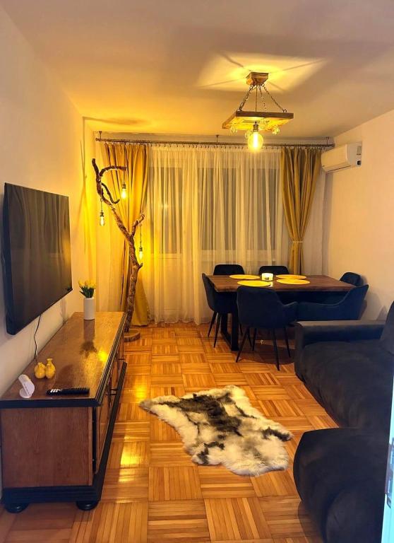 a living room with a couch and a table at Wood&Light in Hunedoara