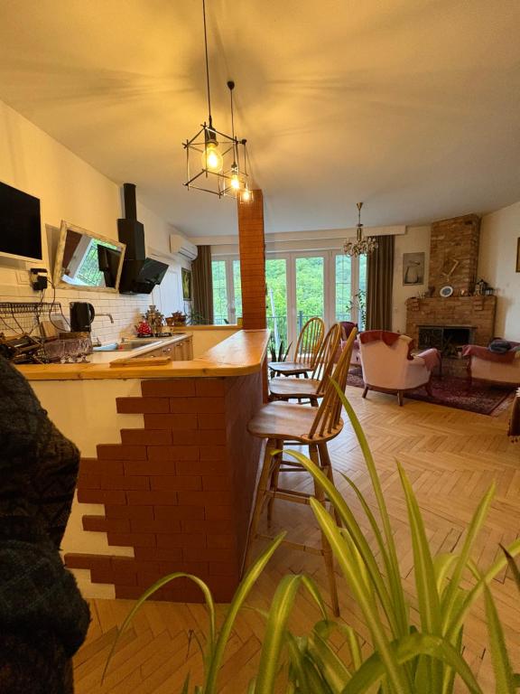 a kitchen and living room with a table and chairs at The nature in Sighnaghi