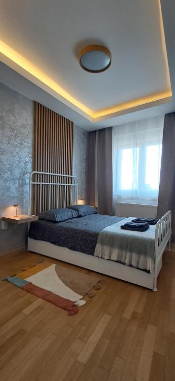 a bedroom with a bed and a window at LuckyCat Apartment in Osijek