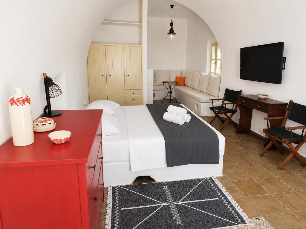 a bedroom with a bed and a living room at Kamara Nest - More than a stay in Aroniadika