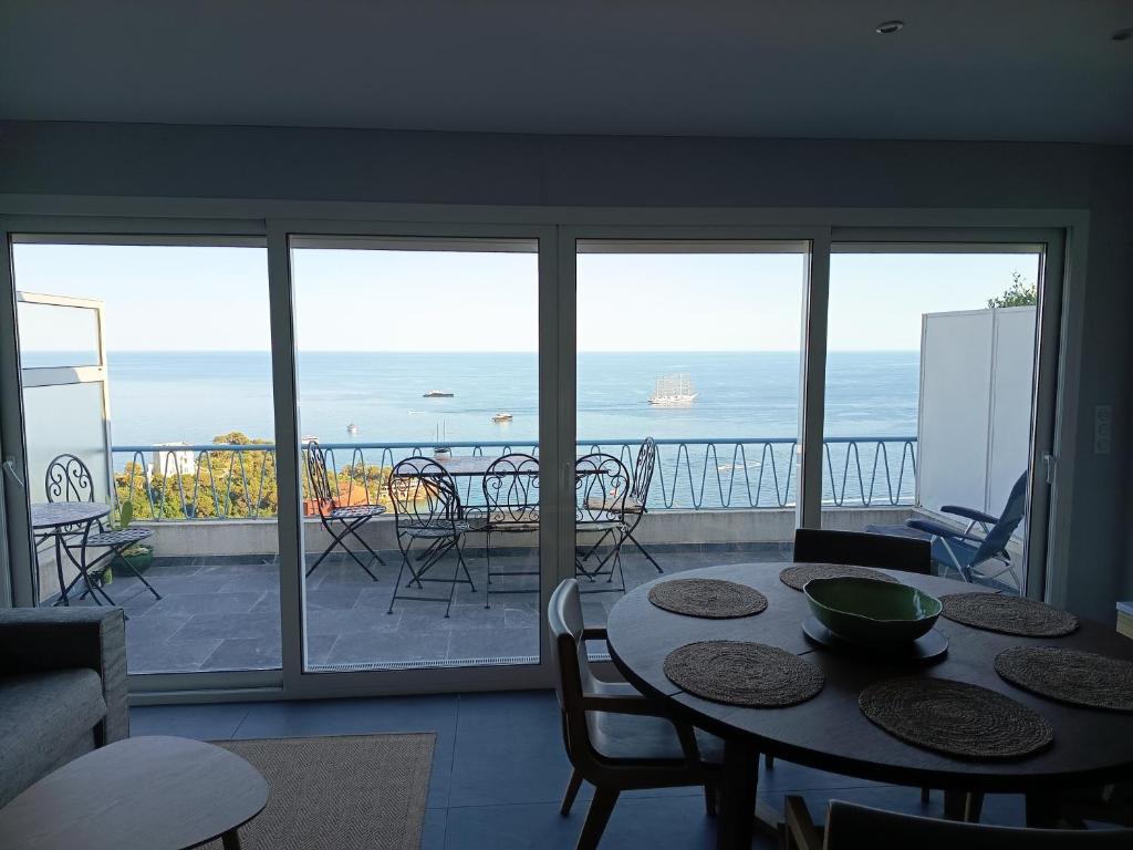 a dining room with a view of the ocean at Duplex Residence with Monte Carlo Sea View & 2 Terraces in Roquebrune-Cap-Martin