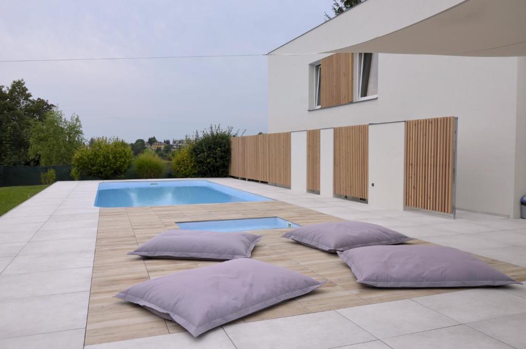 a swimming pool with purple pillows on a patio at Studia a apartmány U Karla in Turnov