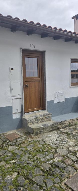 a house with a wooden door on the side of it at Casa do Javali 3 in Bragança