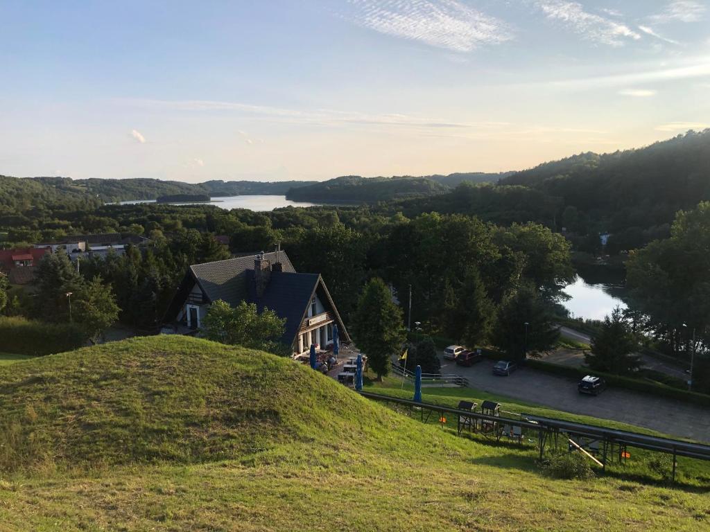 a house on a hill with a view of a lake at MODRA SOBÓTKA - Perła KASZUB in Ręboszewo