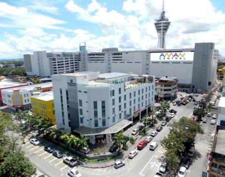 a large building with a large clock tower at Fuller Hotel in Alor Setar
