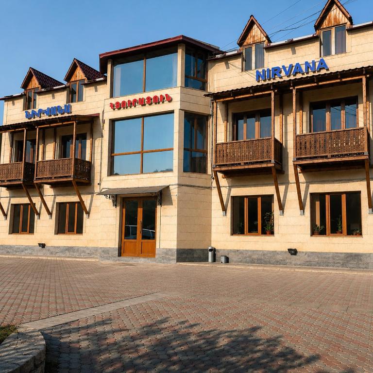 a building with a sign on the front of it at Hotel Nirvana in Dilijan