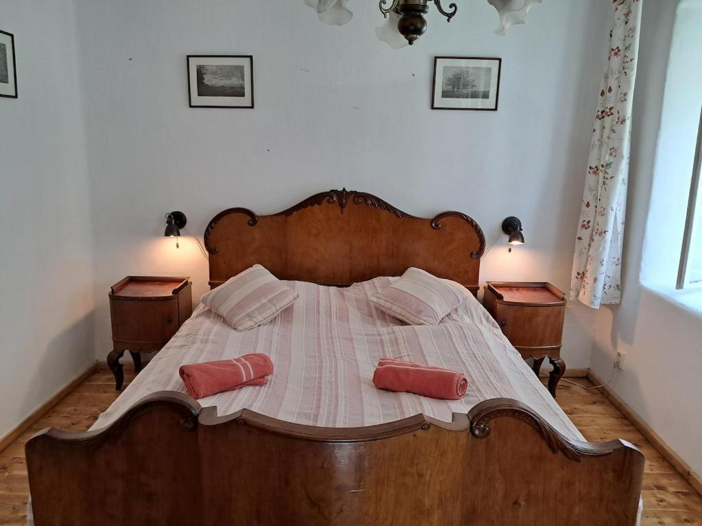 a bedroom with a wooden bed with two pillows on it at U Kameníků in Lhenice
