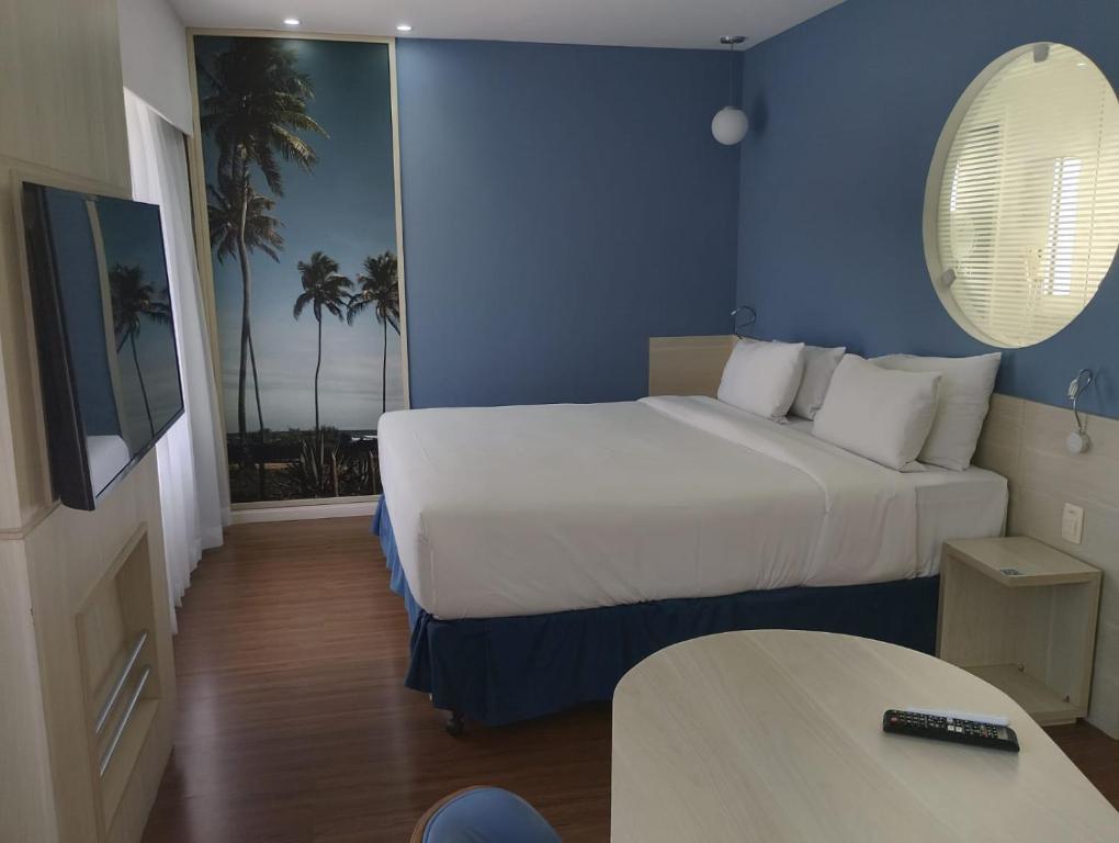 a hotel room with two beds and a table at Apart hotel Mercure boa viagem in Recife