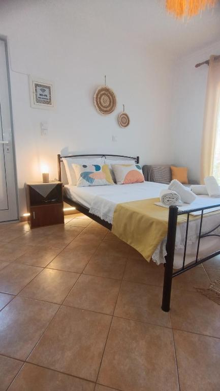 a bedroom with a large bed in a room at Ammoudeli Coastal Escape in Plomari