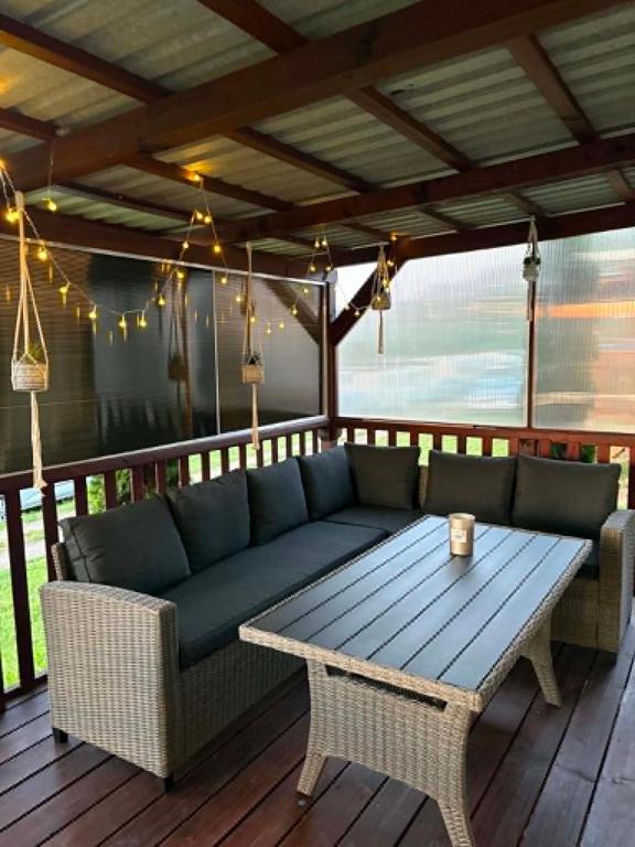 a couch and a table on a deck at Mobilheim Výr in Výrovice