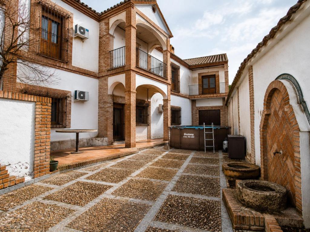 a courtyard of a house with a ping pong table at Casa Dorrego Toledo in Cabañas de la Sagra