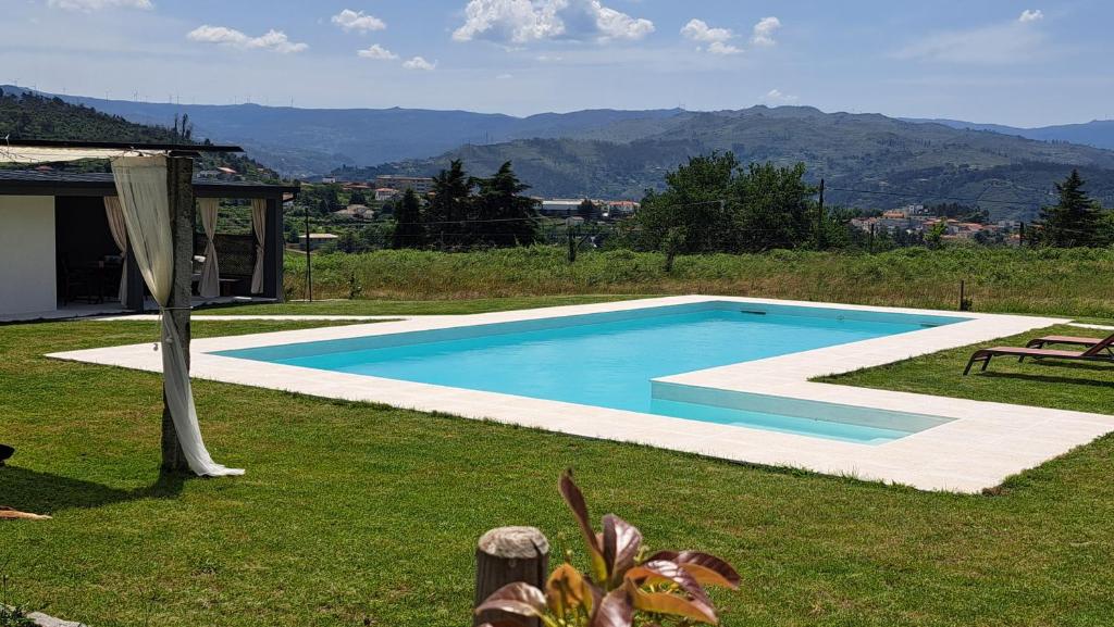 a swimming pool in the middle of a yard at Solar da Motta Douro Boutique Home in Ancede