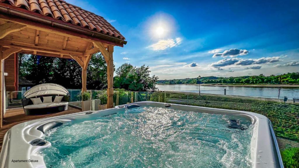 a hot tub in front of a gazebo at Bulwar Residence & Wellness in Kazimierz Dolny