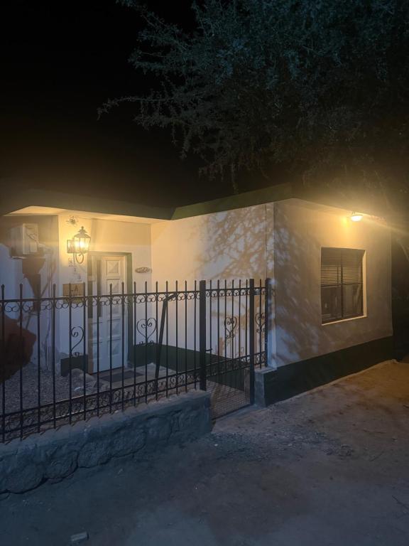 a house with a gate in front of it at night at La Niña in Belén