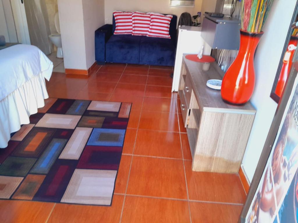 a living room with a couch and a tile floor at Ecogreen on End in Northam
