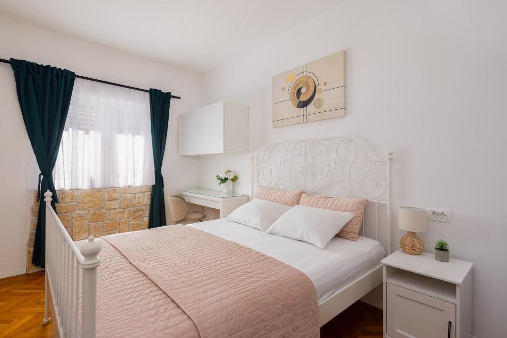 a bedroom with a white bed and a window at Villa ELENA Room Old Town in Rogoznica