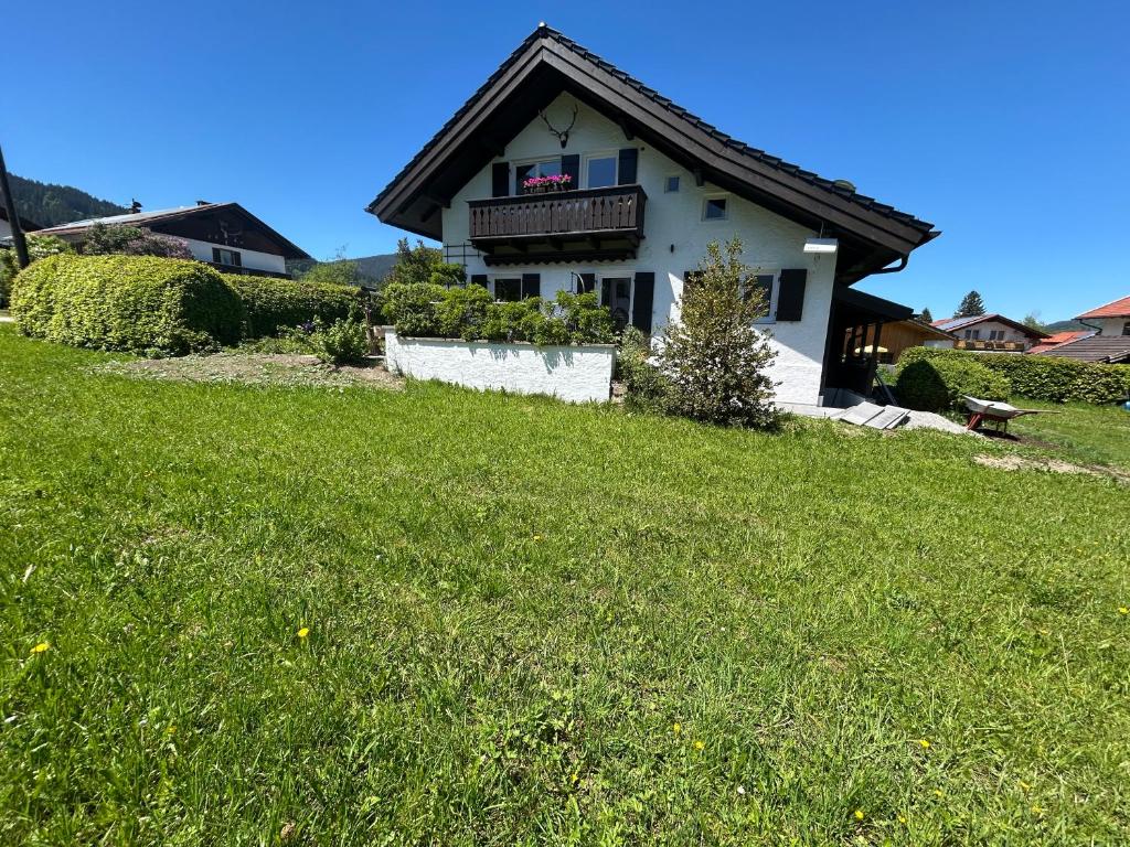 a house with a green lawn in front of it at Ferienhaus Luisl & Hilde in Unterammergau