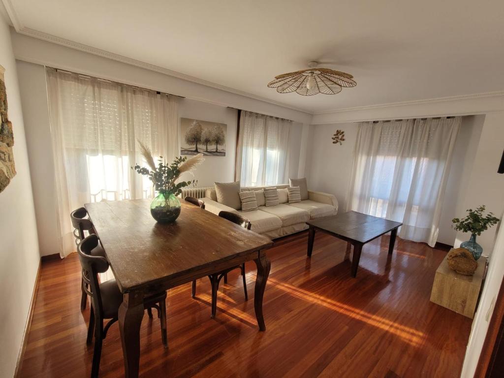 a living room with a table and a couch at ZiRALLA in Allariz