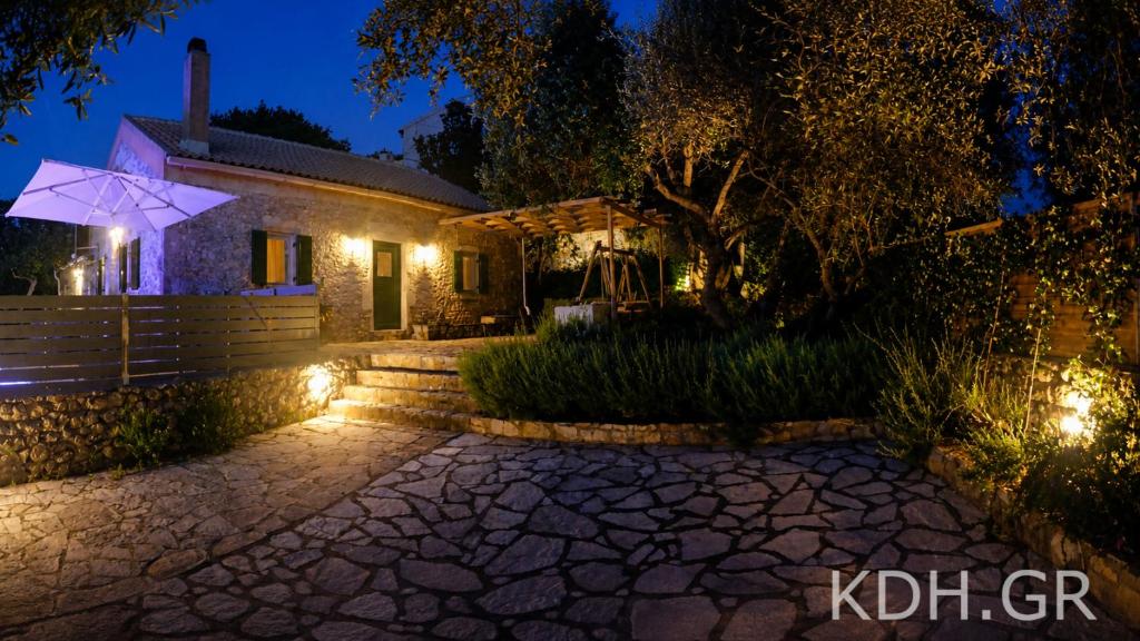 a house with lights in front of it at night at Private Villa Demetra 1768 with pool - close to Fiskardo in Fiskardo