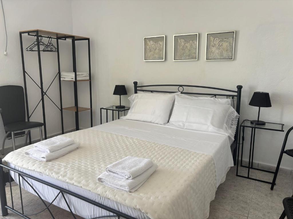a bedroom with a bed with two towels on it at Kambi rooms in Himare