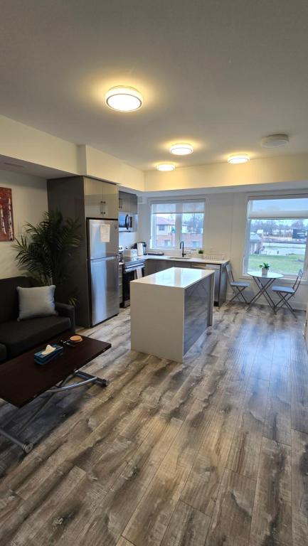 a large living room with a kitchen and a living room at Stylish Townhome Gem with Several Amenities Just Minutes To The Falls in Niagara Falls