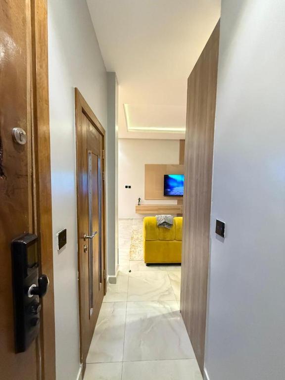 a hallway with a yellow couch in a room at Starella Apartments in Lekki