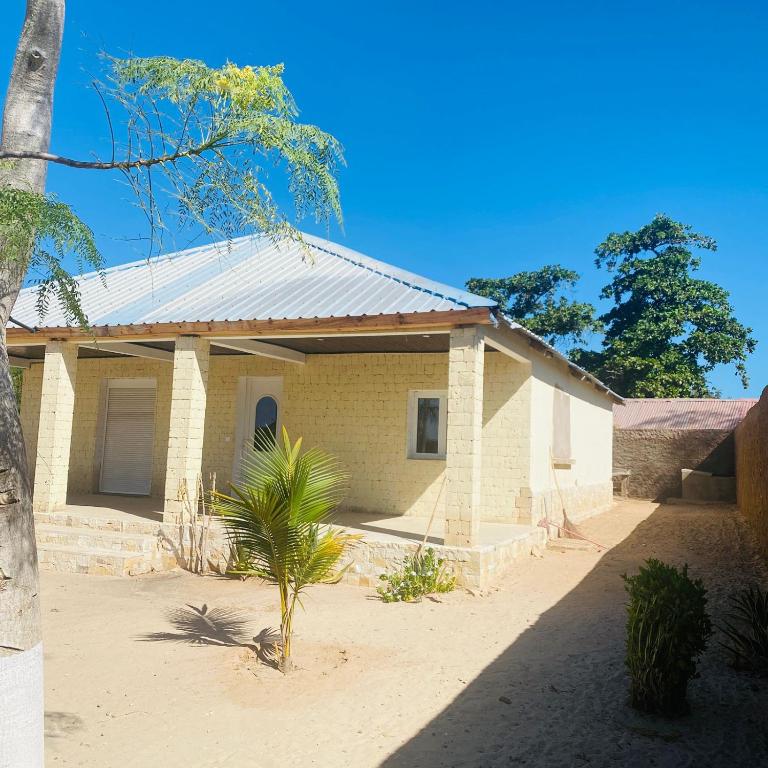 a small brick house with a tin roof at Le Jardin du soleil in Ifaty