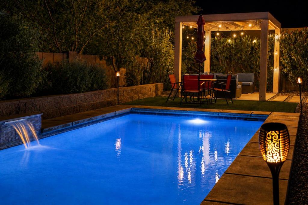 a swimming pool in a backyard at night at Lighted Pool Nights Fenced Yard & Mountain View in Tucson