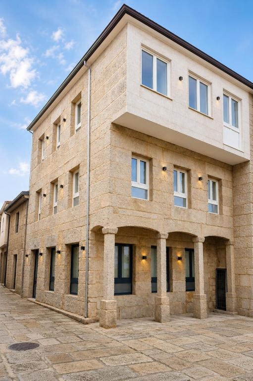 a large brick building with windows at Apartamentos Dulce Estrela in Tui