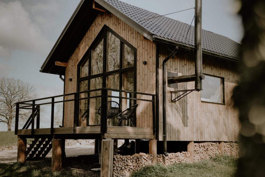 a cabin with a large window on the side of it at Nitaure Glamping in Viļums